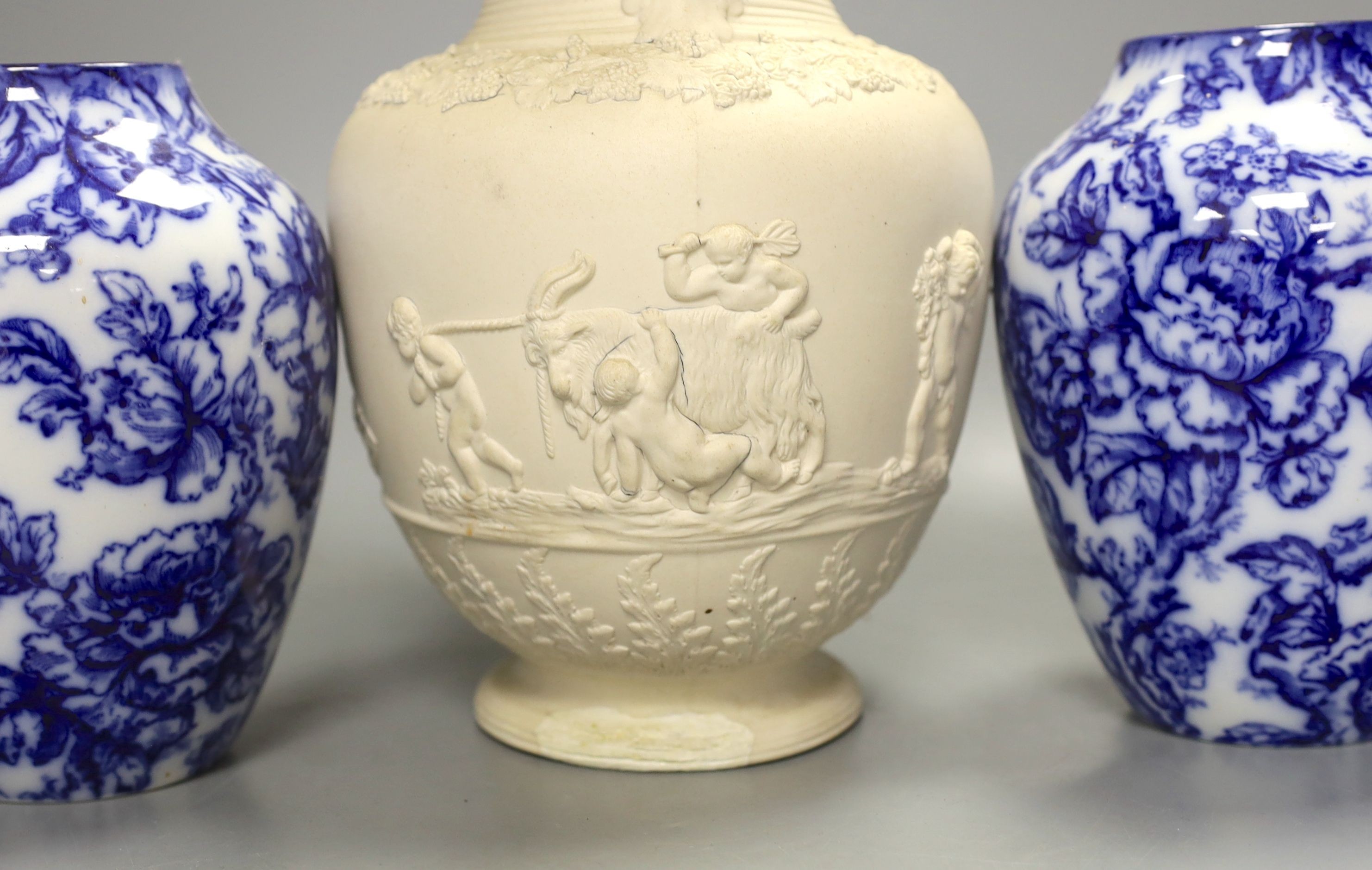 A pair of Keelings blue and white floral vases and a 19th century relief moulded white stoneware jug, vases 17 cms high.